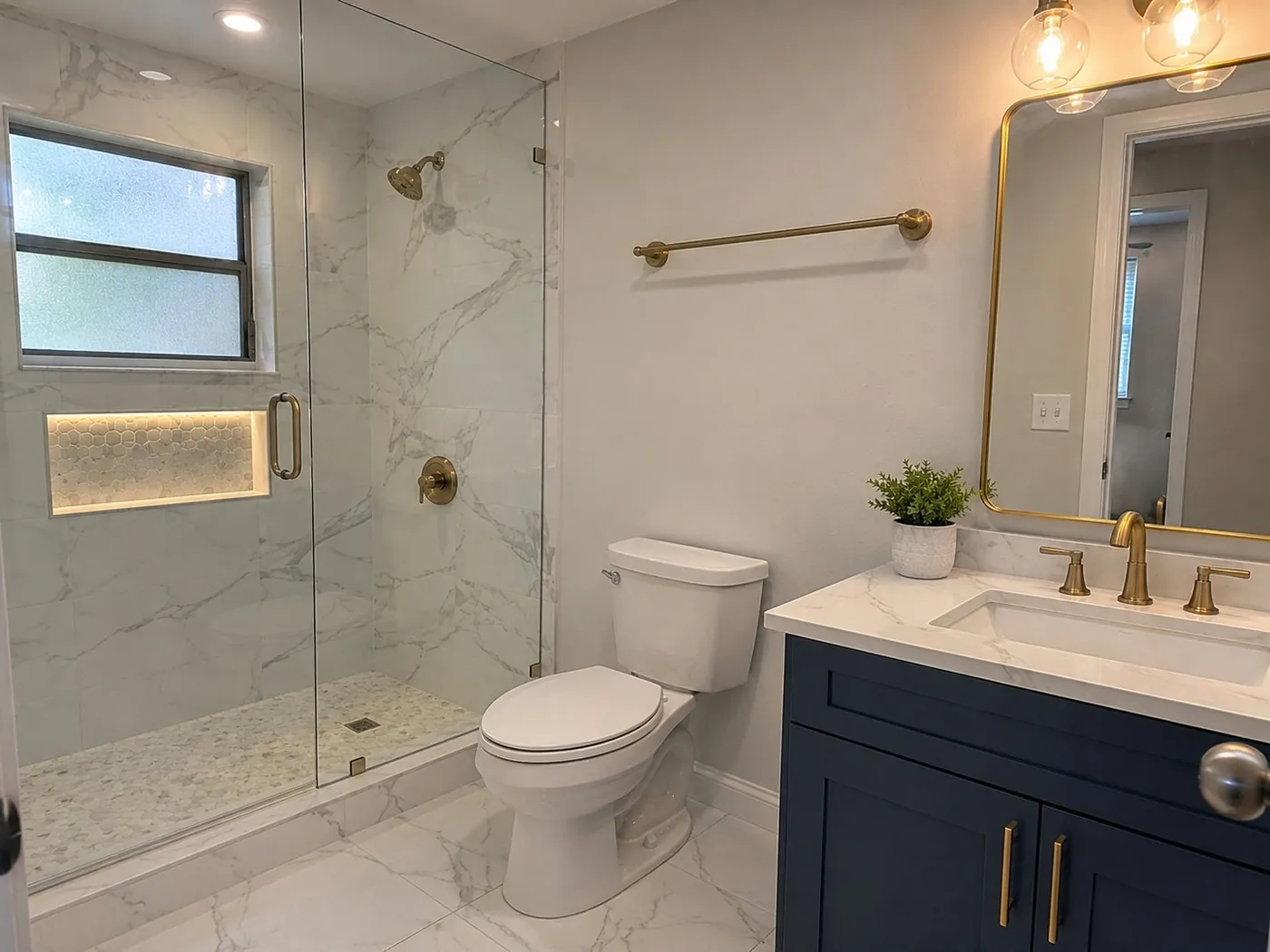 Bathroom remodel with marble walk-in shower and gold fixtures