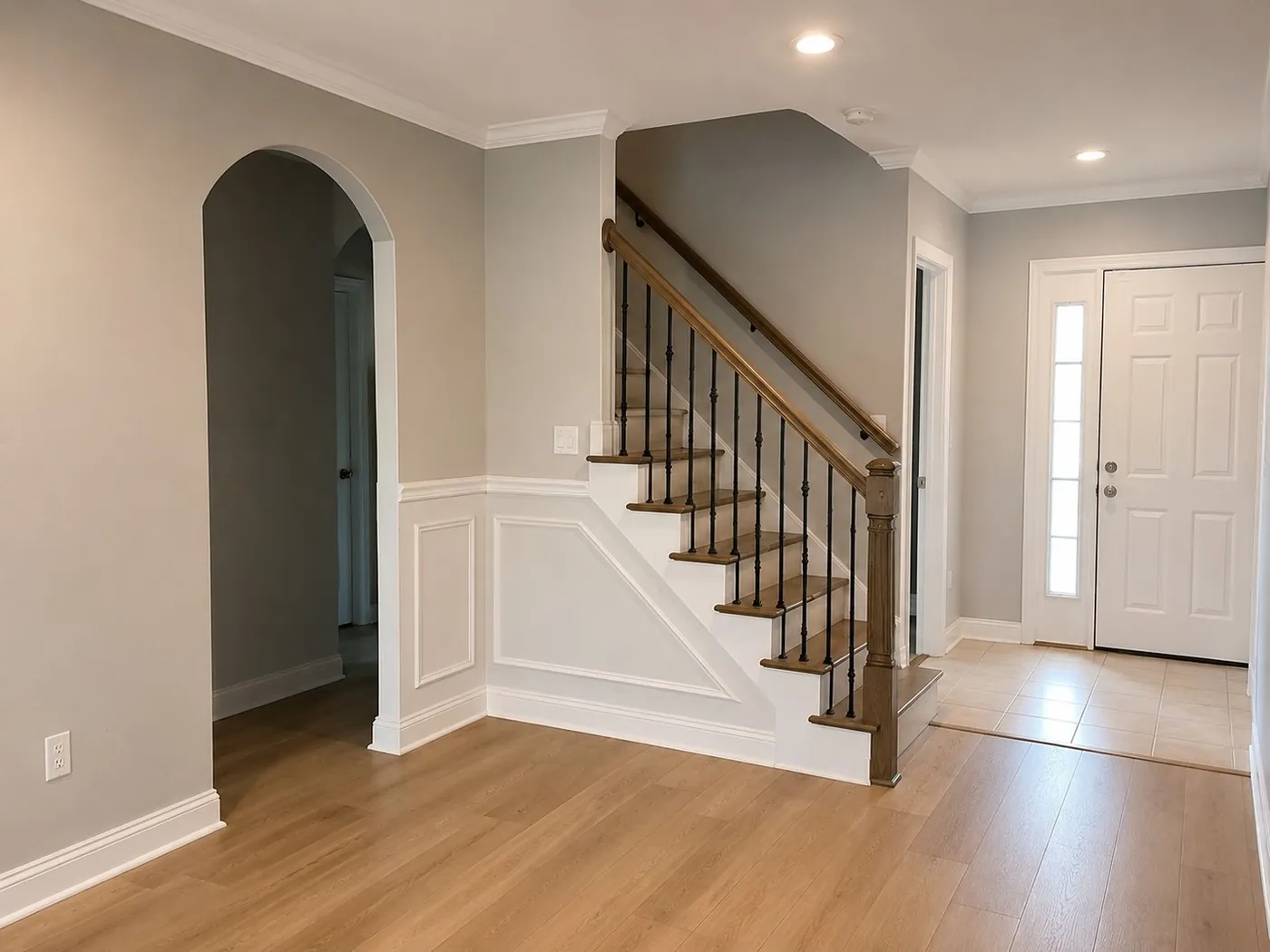 Entry hall with new wood flooring, wainscoting and refinished staircase