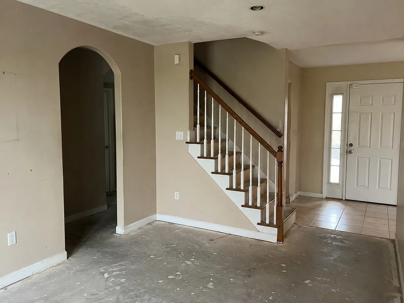 Entry hall stripped to bare concrete before the remodel